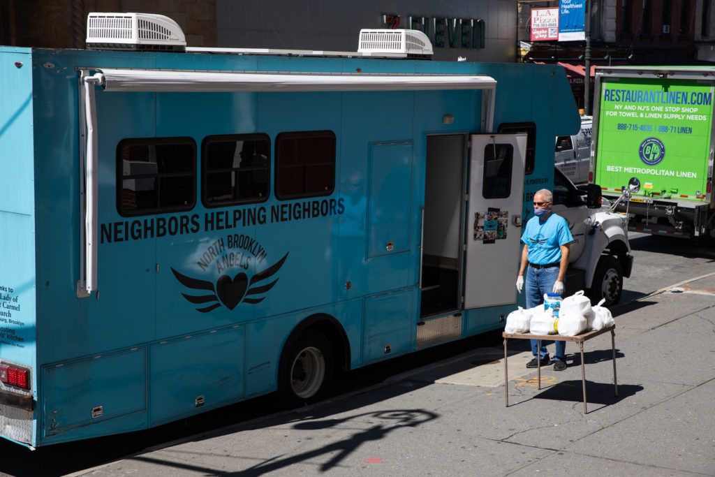 One of the most important aspects of the North Brooklyn Angels, their Angelmobile, cannot be used at it once was. Instead of getting food from the vehicle's service window, passersby have to pick up pre-packaged meals from a table on the sidewalk, due to social distancing rules. Photo: Paul Frangipane/Brooklyn Eagle One of the most important aspects of the North Brooklyn Angels, their Angelmobile, cannot be used at it once was. Instead of getting food from the vehicle's service window, passersby have to pick up pre-packaged meals from a table on the sidewalk, due to social distancing rules. Photo: Paul Frangipane/Brooklyn Eagle