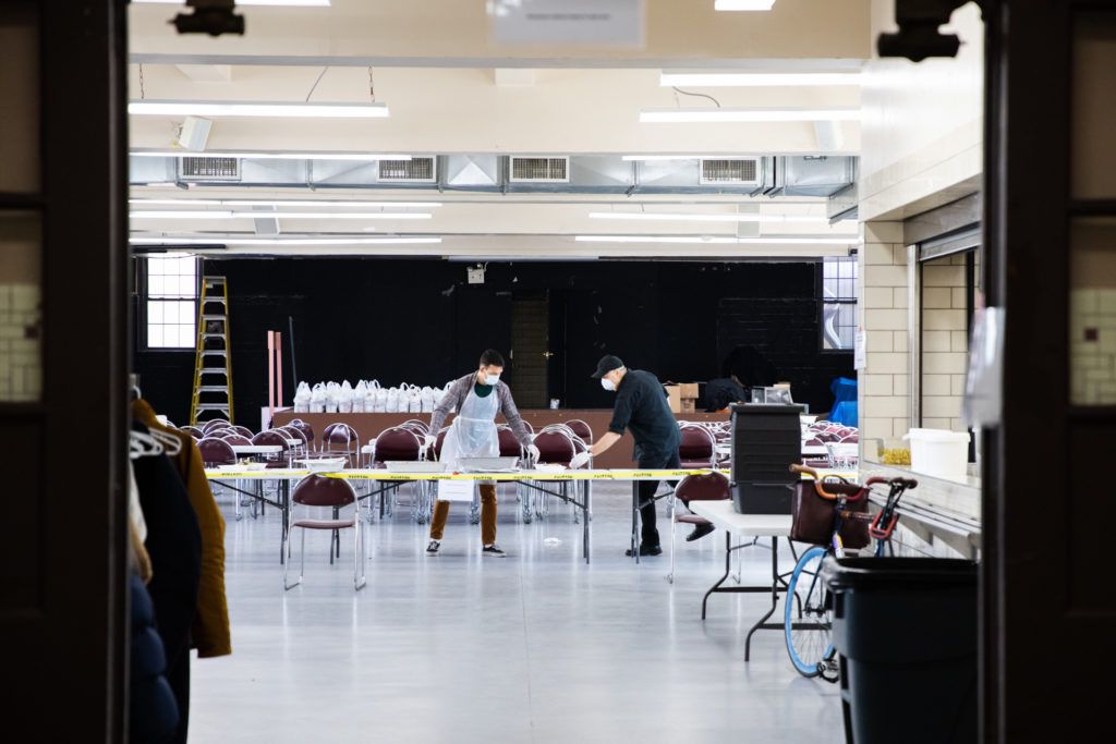 Angels volunteers form a human assembly line to prepare meals for their neighbors. Photo: Paul Frangipane/Brooklyn Eagle