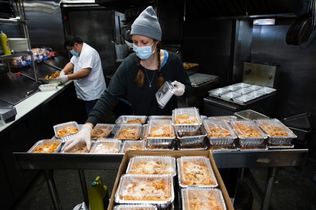Blair Papagni, owner of Jimmy's Diner, packages baked ziti with her kitchen staff for a dinner delivery to health care workers at Woodhull Hospital. Photo: Paul Frangipane/Brooklyn Eagle Blair Papagni, owner of Jimmy's Diner, packages baked ziti with her kitchen staff for a dinner delivery to health care workers at Woodhull Hospital. Photo: Paul Frangipane/Brooklyn Eagle
