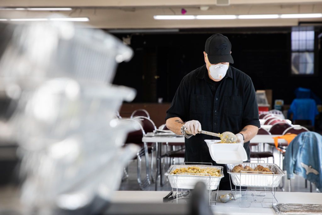 Paul Samulski, president of the North Brooklyn Chamber of Commerce and daily volunteer with North Brooklyn Angels preps hundreds of to-go containers of food for those in need. Photo: Paul Frangipane/Brooklyn Eagle